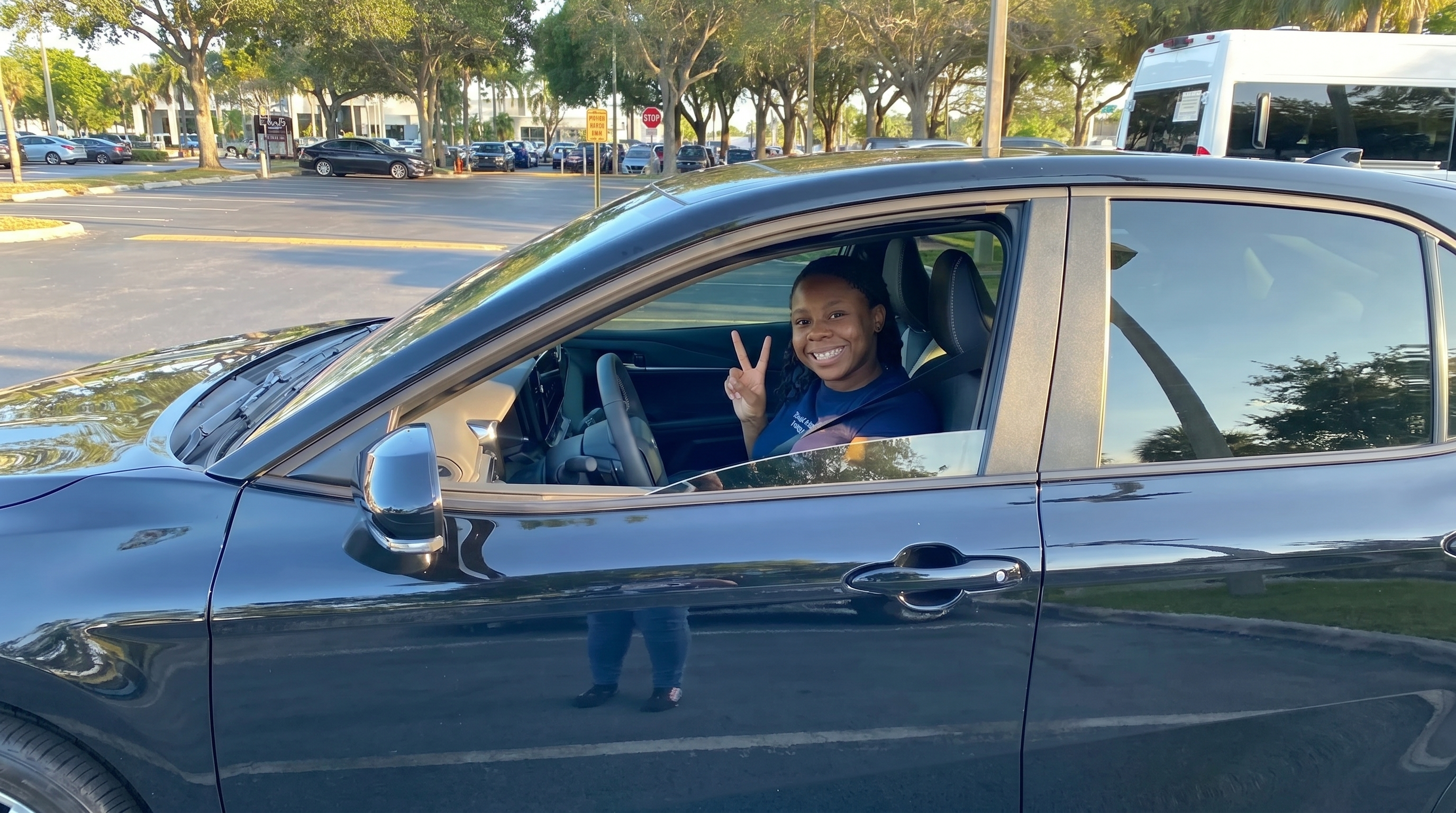 Buyer smiling from inside a newly purchased vehicle